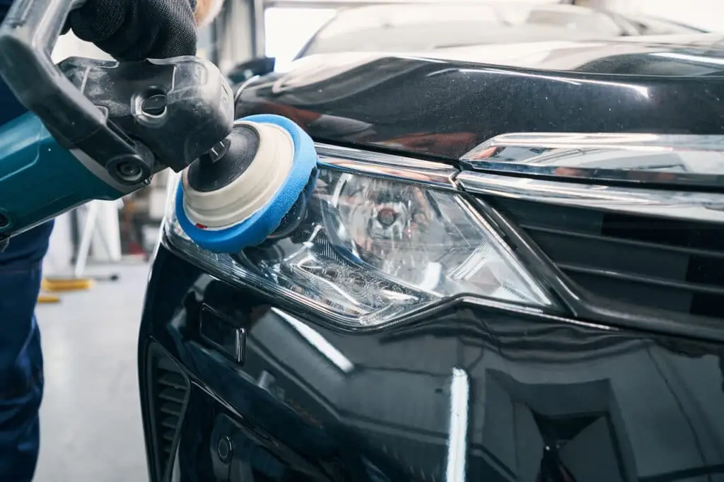 Restored headlights on luxury sedan after detailing service